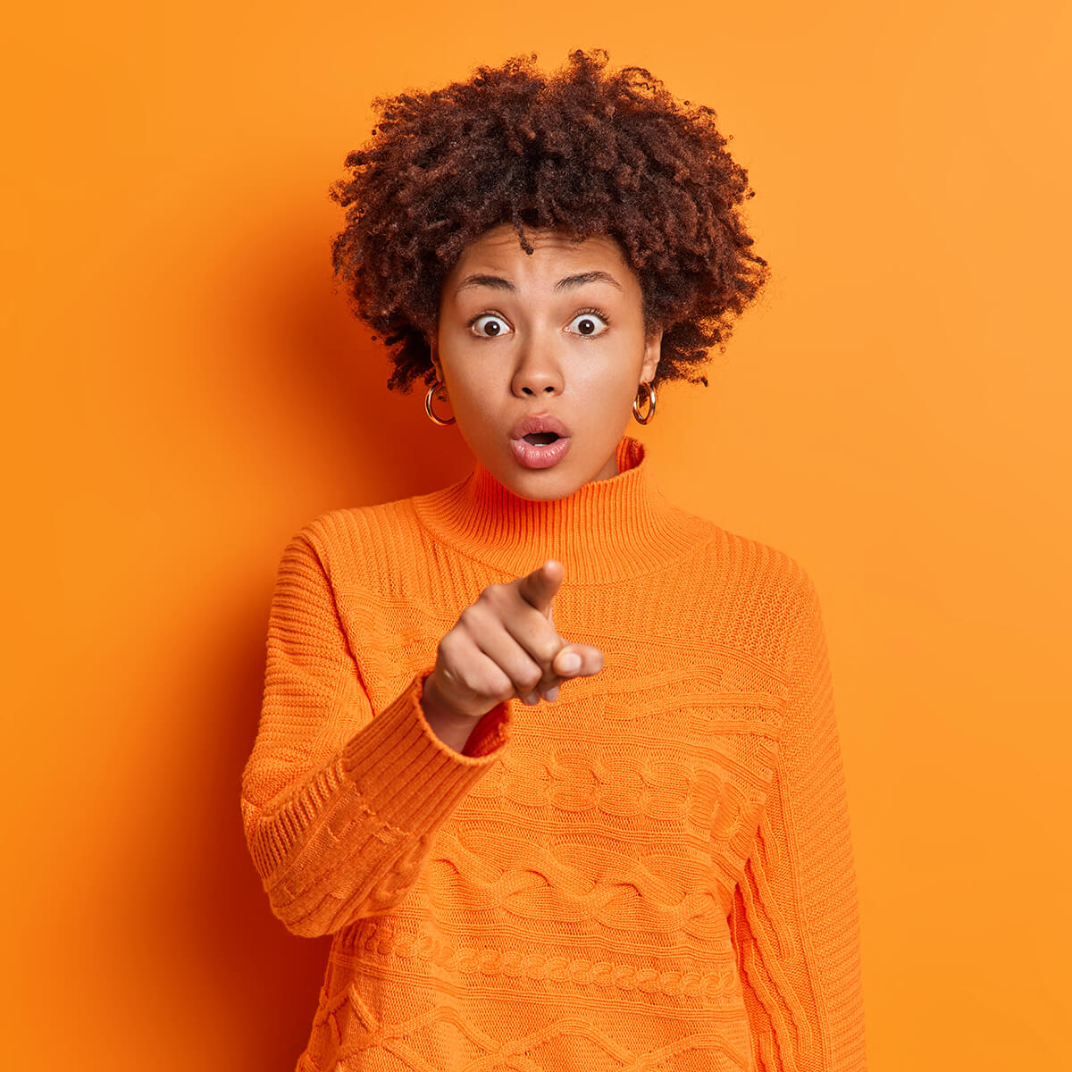emotive-afro-american-woman-with-curly-hair-stares-L6KT9X8.jpg